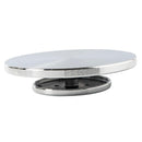 Round metal object with a white top and black bottom on a white background