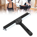 Black squeegee with a blurred background of people in an art studio.