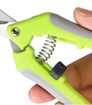 Hand holding a green and gray hand gripper