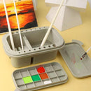Gray art supply set with paintbrushes and color swatches on a yellow background