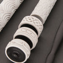 Close-up of white textured handles on a dark surface