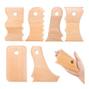 Set of wooden tools with a hand holding one, on a white background