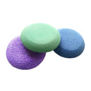 Three colorful sponges (purple, green, blue) on a white background