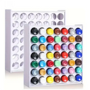 Colorful nail polish bottles in a white rack with a white background