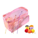 Pink mesh storage bag with knitting needles and colorful yarn on a white background