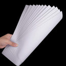 Hand holding a stack of white sheets with lines on a black background