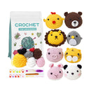 Crochet kit with yarn balls and animal-themed crochet toys on a white background