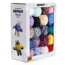 Box of Bernat Velvet minis yarn with colourful skeins and knitted toys on a white background