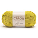 Ball of yellow yarn with Caron label on a white background