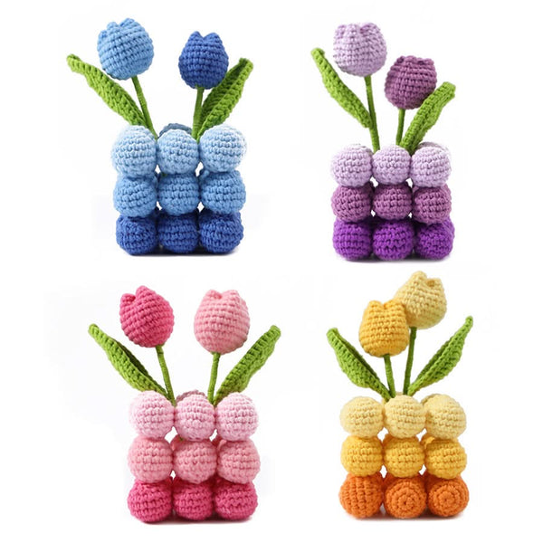 Set of four crocheted tulip flowers in blue, purple, pink, and orange on a white background.