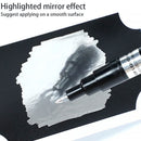 Black marker applying a mirror effect on a white surface with text guidance.