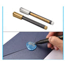 Metallic color pen with a hand applying a blue wax seal on a piece of paper.
