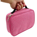 Pink toiletry bag with a hand holding it on a white background