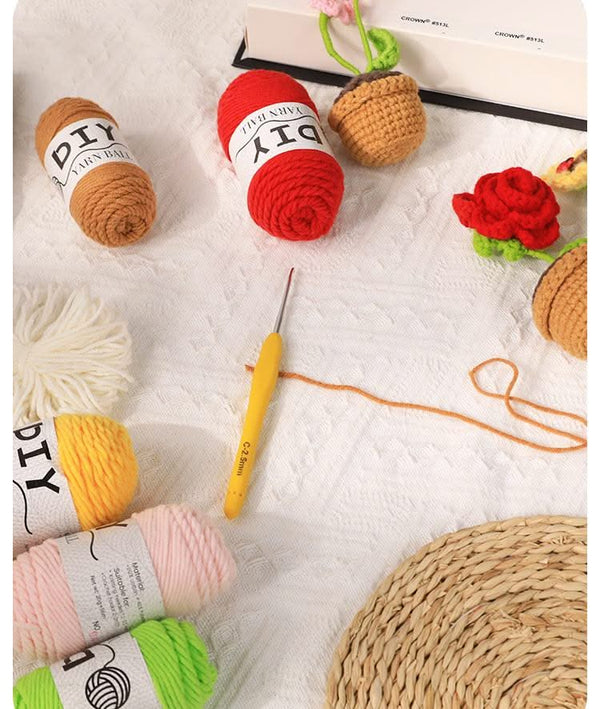 Colorful yarn balls with a crochet hook on a textured surface