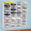 White storage rack with multiple compartments filled with various items against a light blue wall.
