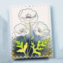 Metallic flower die cut on a light blue background