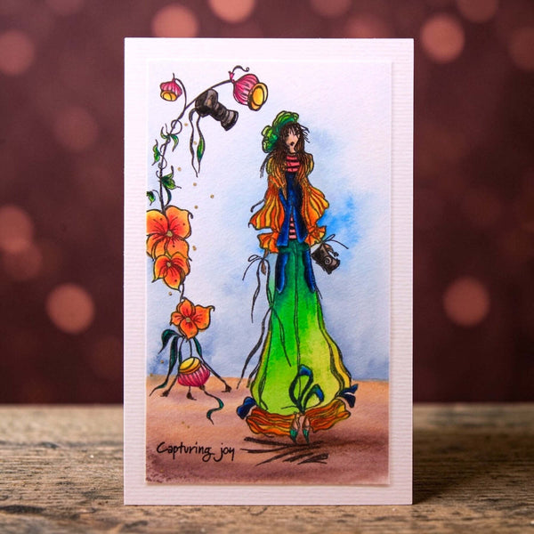 Colorful illustration of a person with flowers on a card with a blurred background
