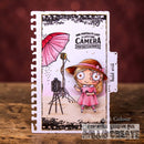Illustrated card with a girl holding a pink umbrella and camera, featuring text about portraits and prints.