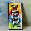 Framed artwork with colorful butterfly designs on a textured wall background