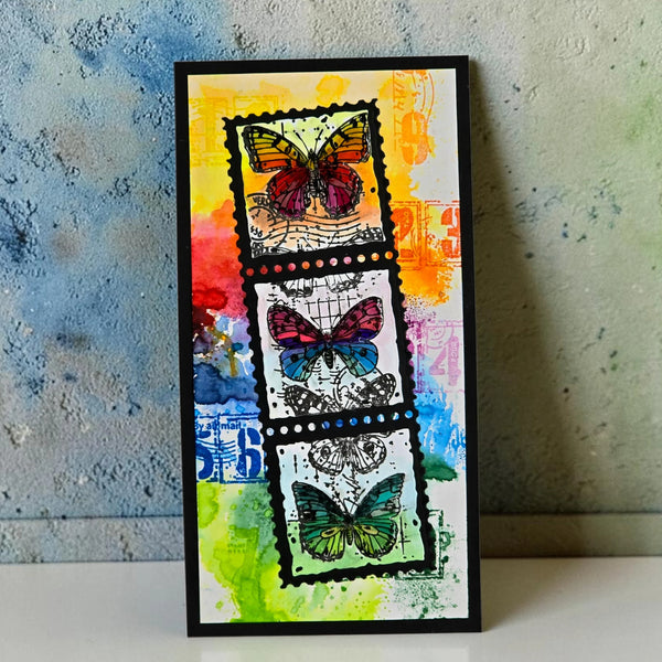 Framed artwork with colorful butterfly designs on a textured wall background