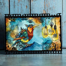 Colorful artwork with a bird, light bulbs, and mechanical elements on a wooden surface.