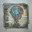 Card with steampunk hot air balloon design and 'Adventure' and 'Experience' text on a textured surface.
