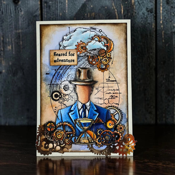 Decorative card with steampunk design featuring gears, a hat, and a suit on a dark wooden background.