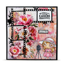 Decorative card with floral design, vintage camera, and cartoon girl in a pink dress.