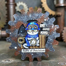 Decorative item with a cat in goggles and a clock, surrounded by gears and mechanical elements.