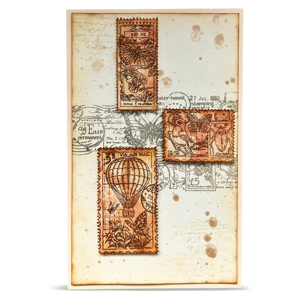 Decorative paper with vintage-style postage stamps featuring hot air balloons and other designs.