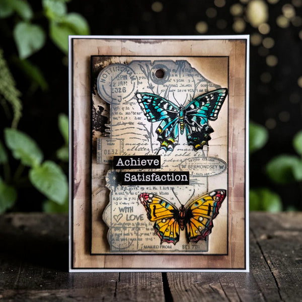 Decorative card with butterflies and motivational text on a wooden surface with a blurred natural background