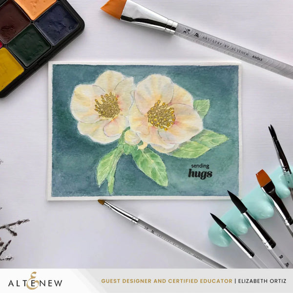 Artistic watercolor card with flowers and 'sending hugs' text, surrounded by painting tools on a white background.