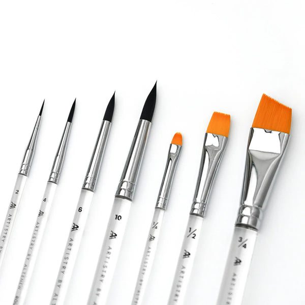 Set of paint brushes with orange bristles on a white background