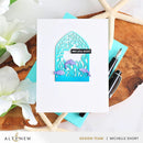 Card with seahorse design and 'sea you soon!' text on a wooden surface with flowers and stationery.