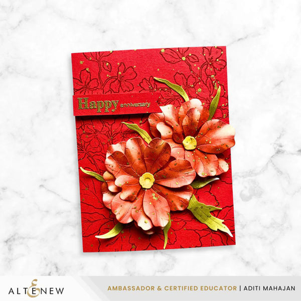 Red anniversary card with floral design on a marble background