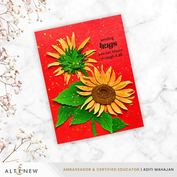 Card with sunflower design and text on a white marble surface, featuring the brand 'Altenew'.