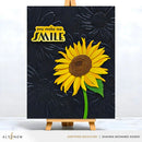 Artistic depiction of a sunflower with 'you make me smile' text on a black background, displayed on an easel.