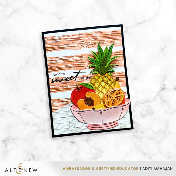 Card with a pineapple and fruits design on a white marble background, featuring the brand 'Altenew'.