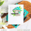 Card with mushrooms and 'So Very Thankful' text on a wooden surface with flowers and pens.