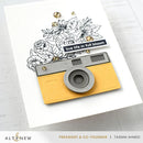 Yellow camera-shaped card with floral design and 'live life in full bloom' text on a white background.