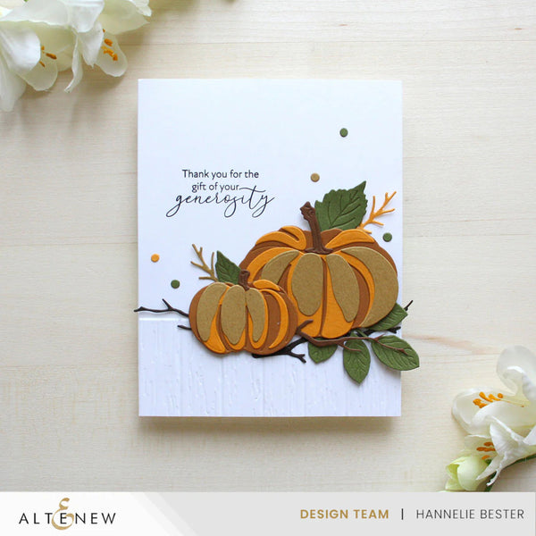 Greeting card with pumpkins and floral elements on a light background, featuring the brand 'Altenew'.