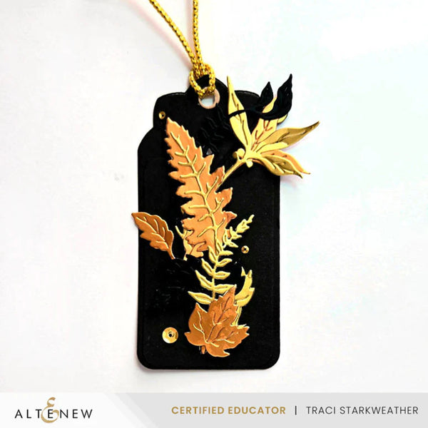 Black tag with gold leaf designs and 'Altenew' branding on a white background