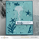 Card with ocean-themed design featuring jellyfish, starfish, and coral on a textured background.