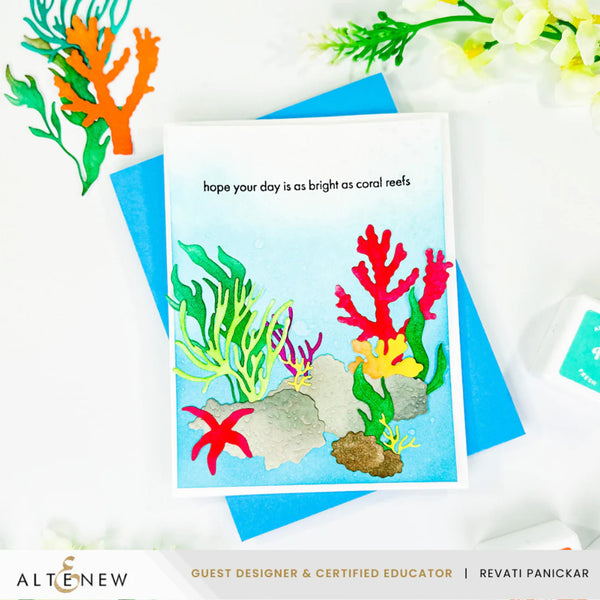 Card with coral reef design and text 'hope your day is as bright as coral reefs' on a white background with flowers.