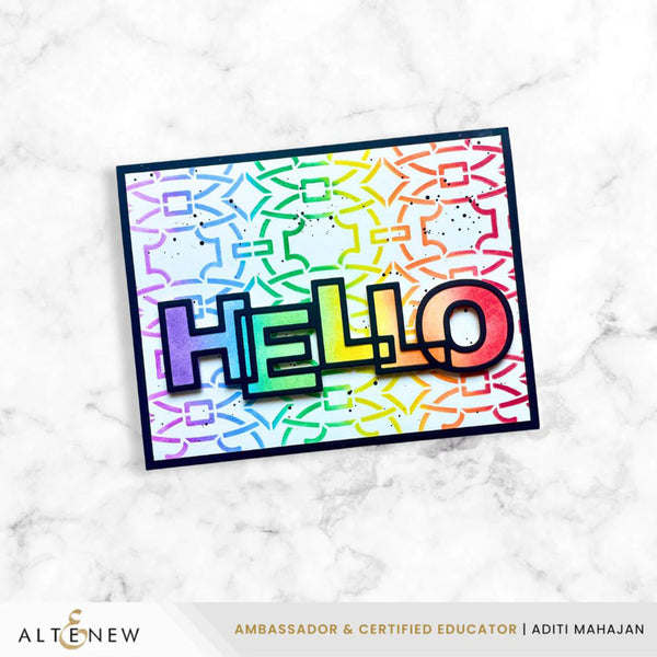 Colorful 'HELLO' card with geometric pattern on a marble background, featuring the Altenew brand.