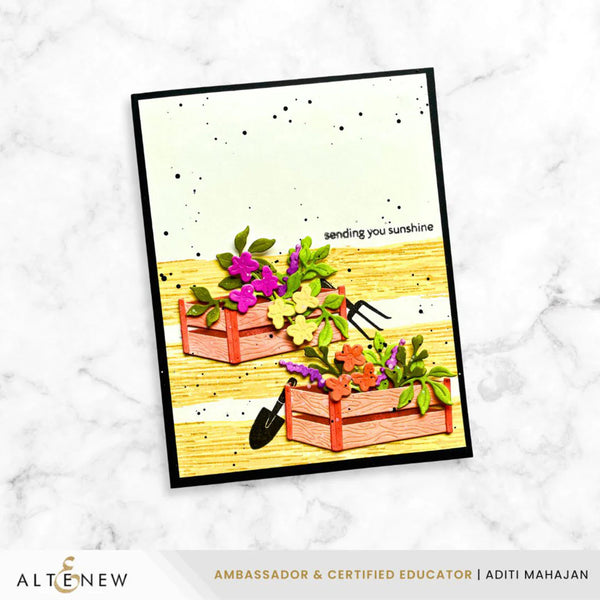 Card with plants and gardening tools on a white marble background, featuring the brand 'Altenew'.