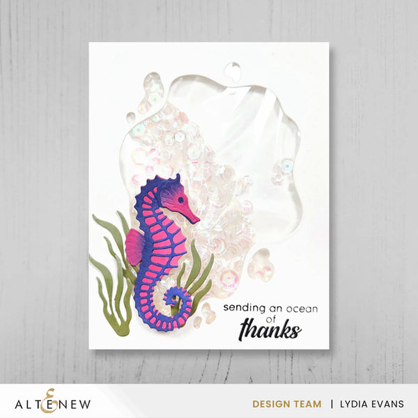 Card with a seahorse illustration and text 'sending an ocean of thanks' on a white background.
