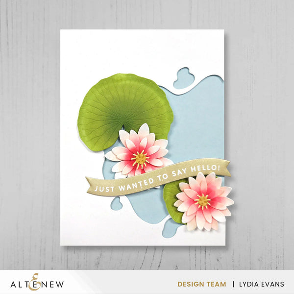 Card with pink flowers and a green lily pad on a white background, featuring the brand 'Altenew'.