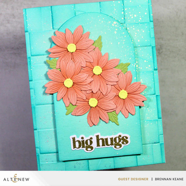 Turquoise card with pink flowers and 'big hugs' text on a gray background