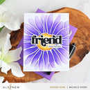 Greeting card with purple flower design and 'friend happy birthday' text on a wooden surface with flowers and a pen.